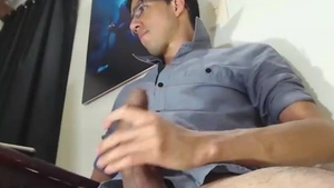 Glassesed twink Strokes His gigantic chubby wang On webcam